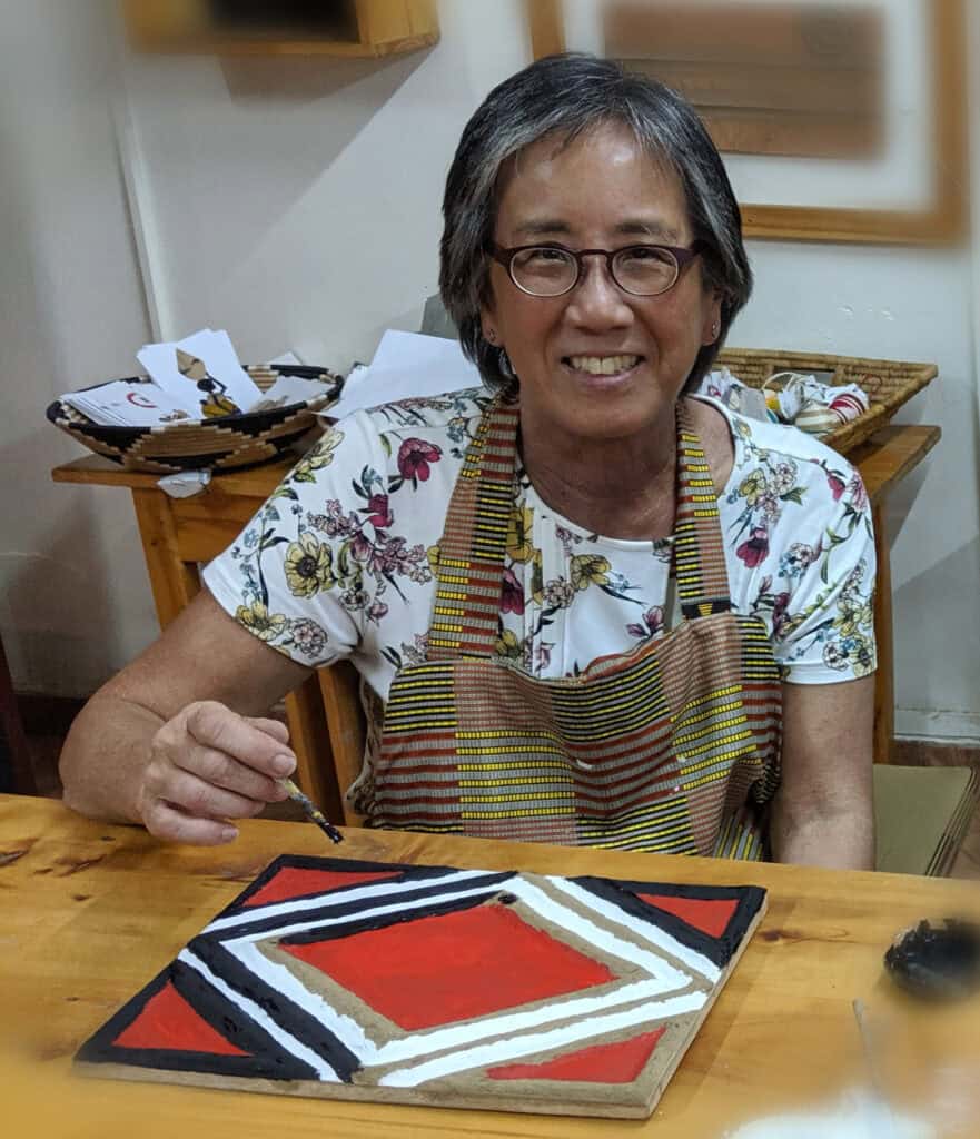 Christine Liu-Perkins making Imigongo (cow dung art) in Kigali, Rwanda